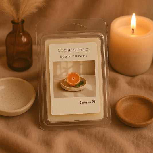 Soy wax melt packaging for Glow Theory by LithoChic, featuring a vibrant orange slice and calming candle.