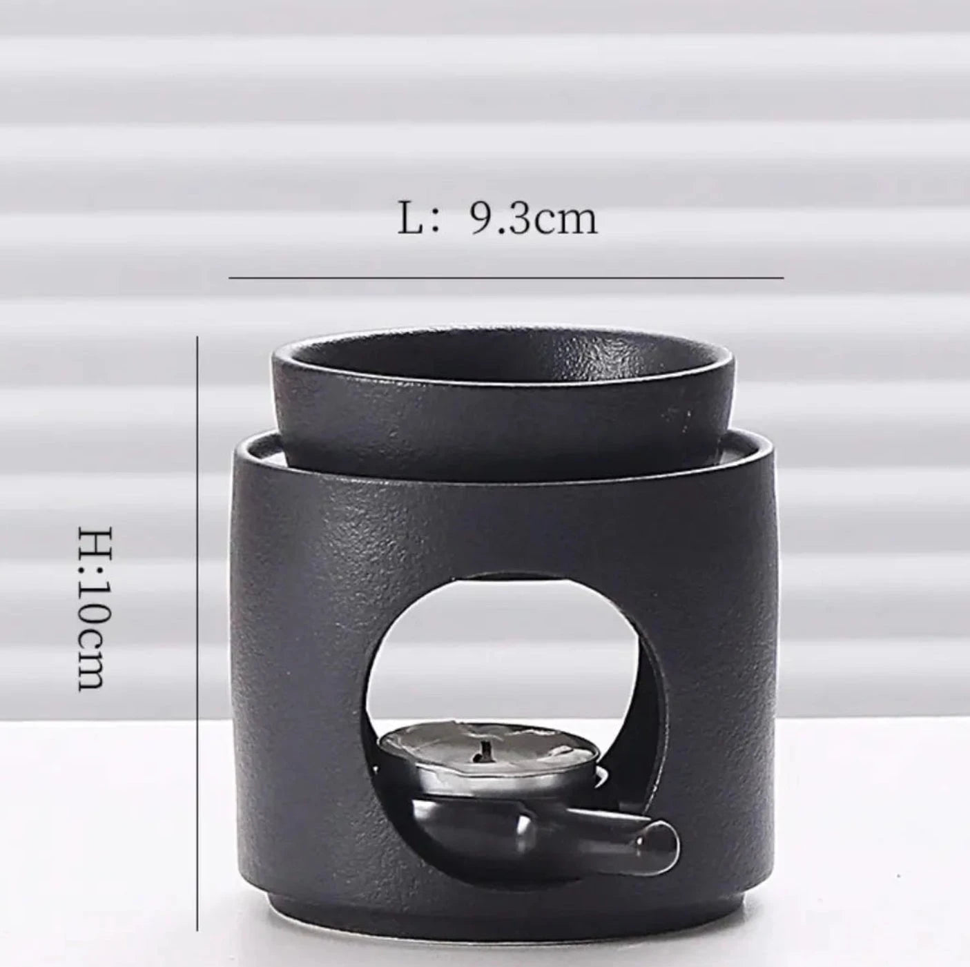 Black ceramic oil burner with measurements on a white background